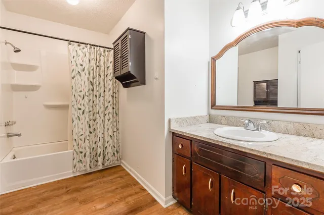 a bathroom with a sink a mirror and a shower