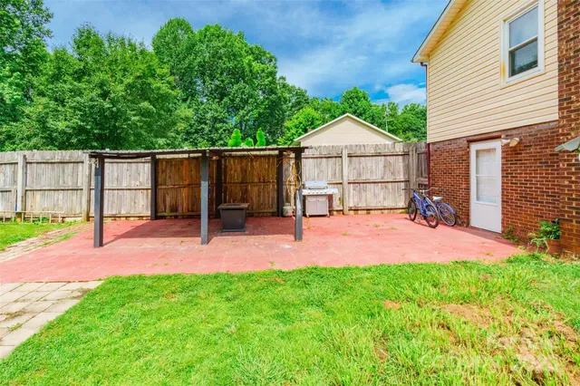 a backyard of a house with table and chairs