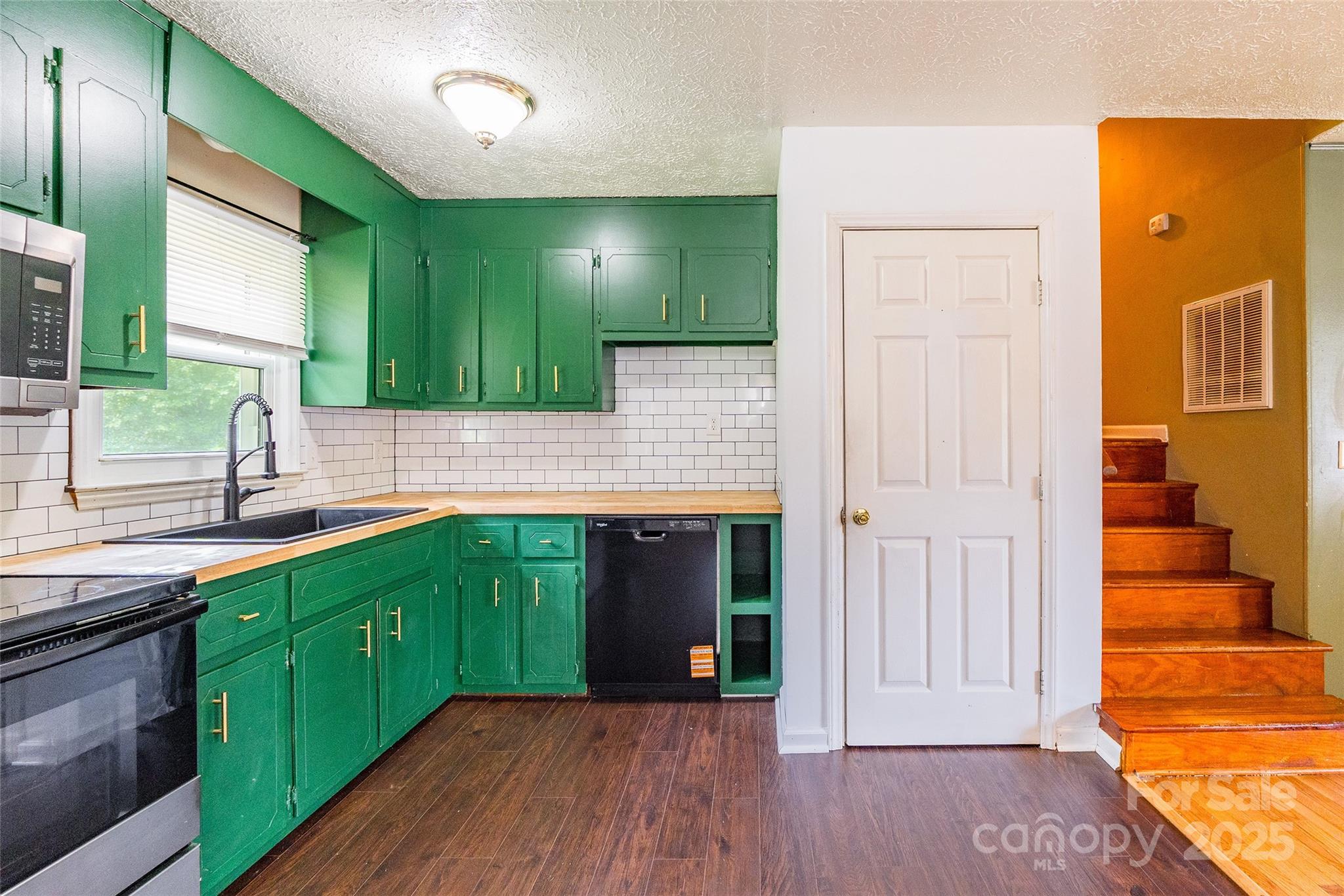 2675 Tablerock Road Lenoir, NC 28645 - Photo 7 of 31 a kitchen with kitchen island granite countertop wooden cabinets and a sink