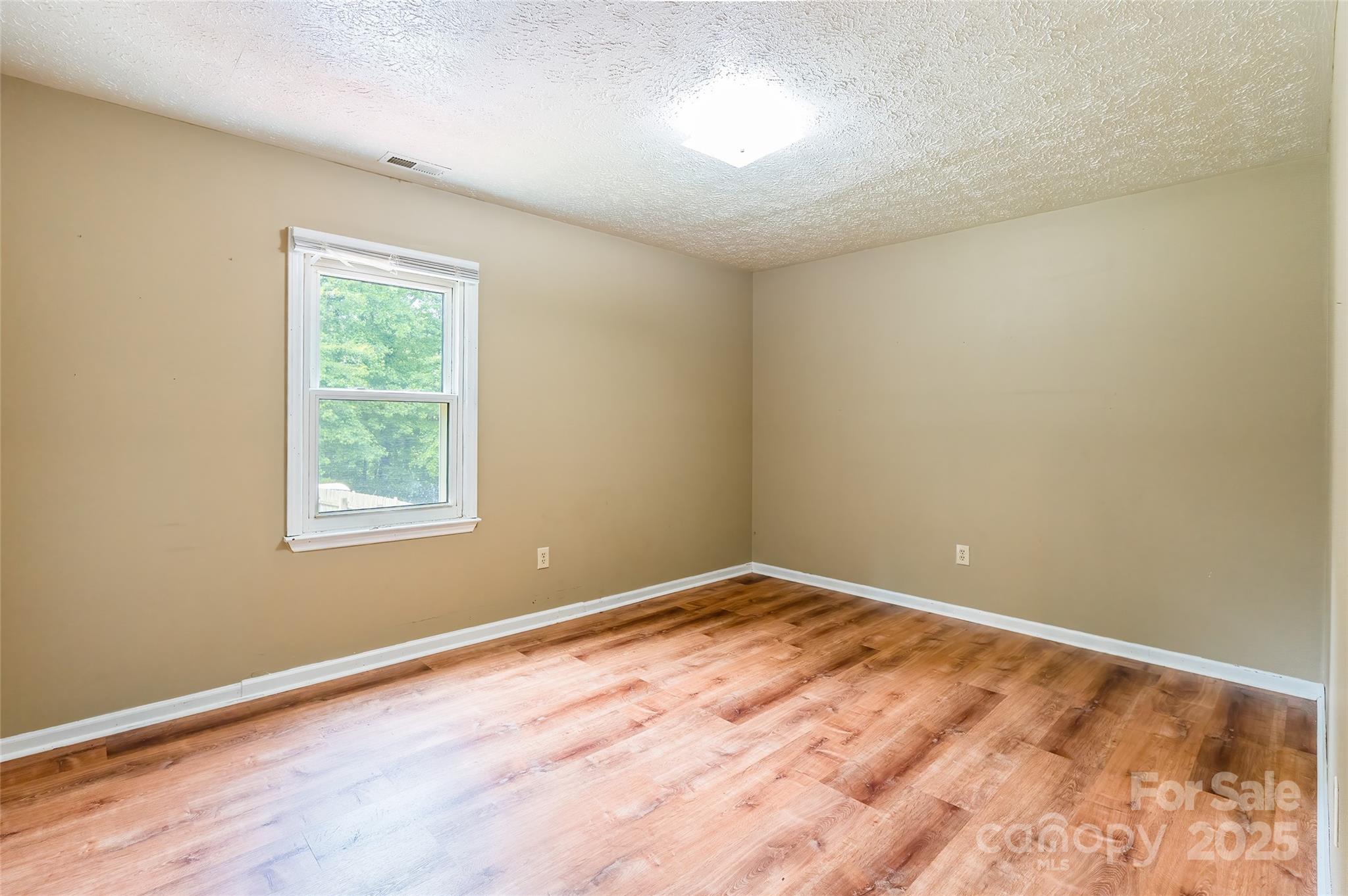 2675 Tablerock Road Lenoir, NC 28645 - Photo 10 of 31 a view of an empty room with wooden floor and a window