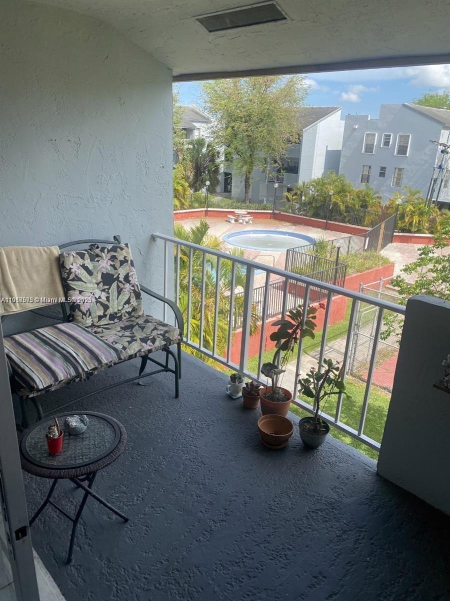 1755 West 60th Street, Unit D304 Hialeah, FL 33012 - Photo 11 of 21 a living room with furniture and a floor to ceiling window