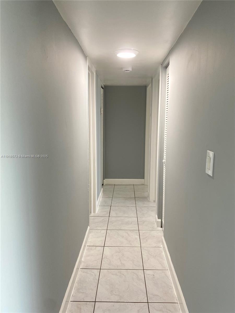 1755 West 60th Street, Unit D304 Hialeah, FL 33012 - Photo 13 of 21 a view of livingroom with an empty space and window