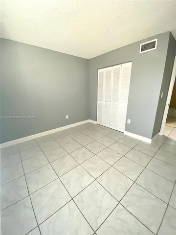 a view of an empty room and a window