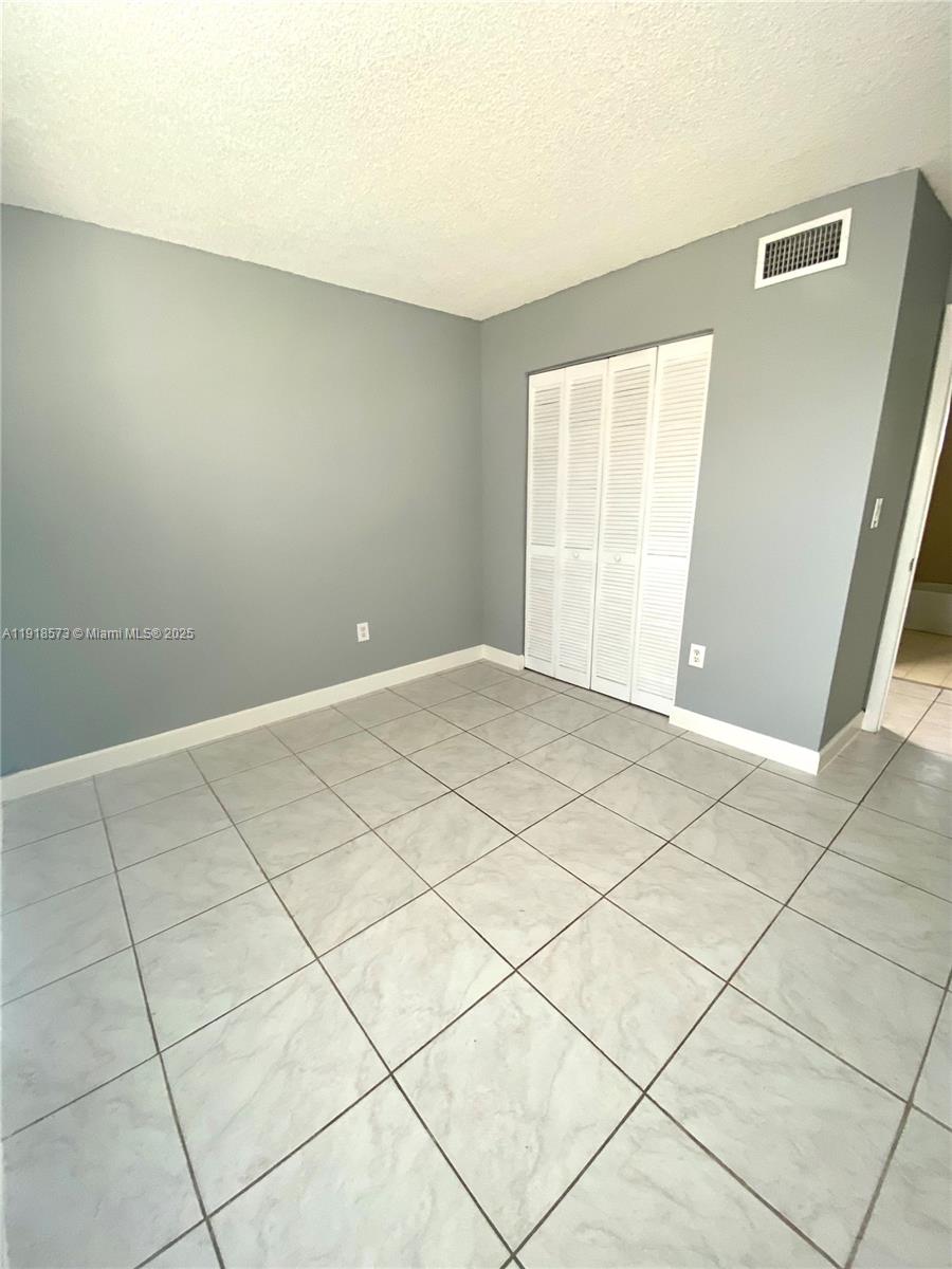 1755 West 60th Street, Unit D304 Hialeah, FL 33012 - Photo 14 of 21 a view of an empty room and a window