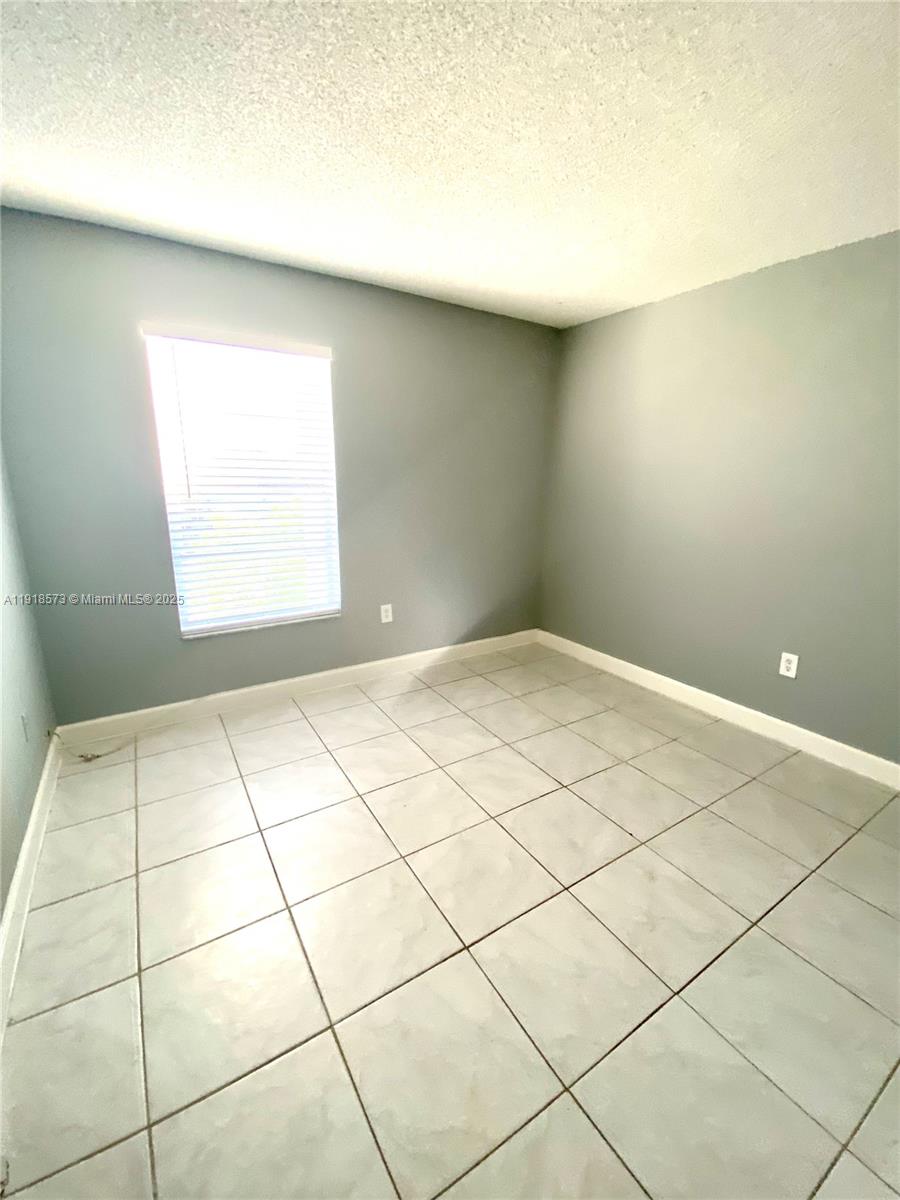 1755 West 60th Street, Unit D304 Hialeah, FL 33012 - Photo 15 of 21 a view of a room with a window