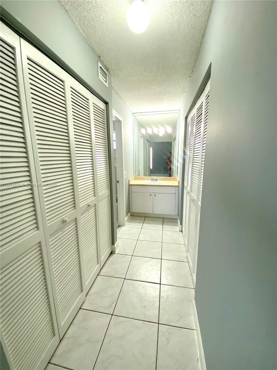1755 West 60th Street, Unit D304 Hialeah, FL 33012 - Photo 19 of 21 a bathroom with a glass door shower and a sink