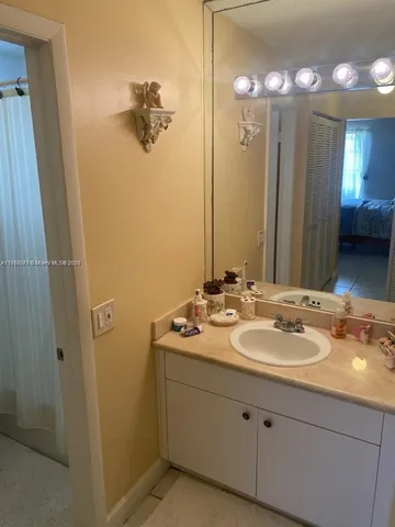 a bathroom with a double vanity sink and mirror