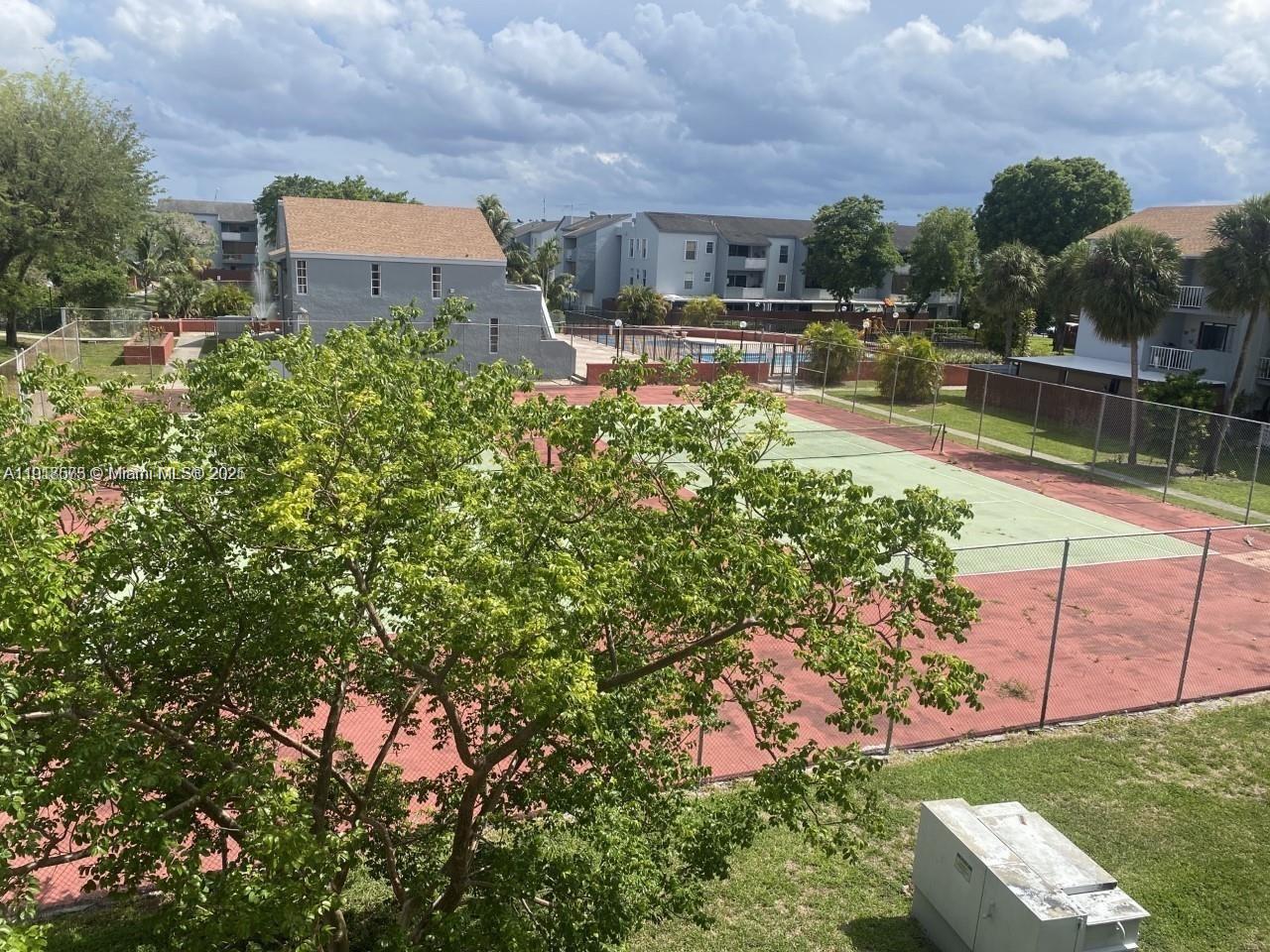 1755 West 60th Street, Unit D304 Hialeah, FL 33012 - Photo 2 of 21 a view of a house with a yard and sitting area