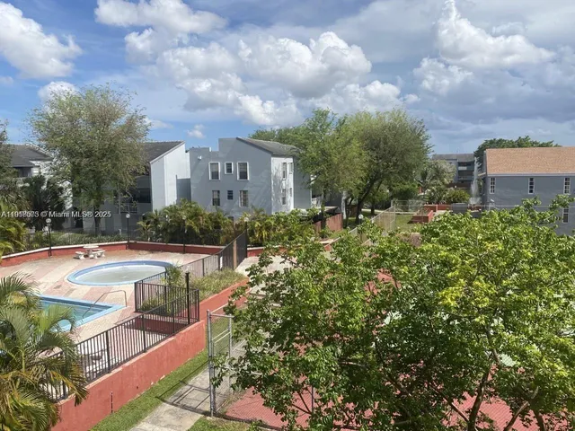 a view of a house with swimming pool and sitting area