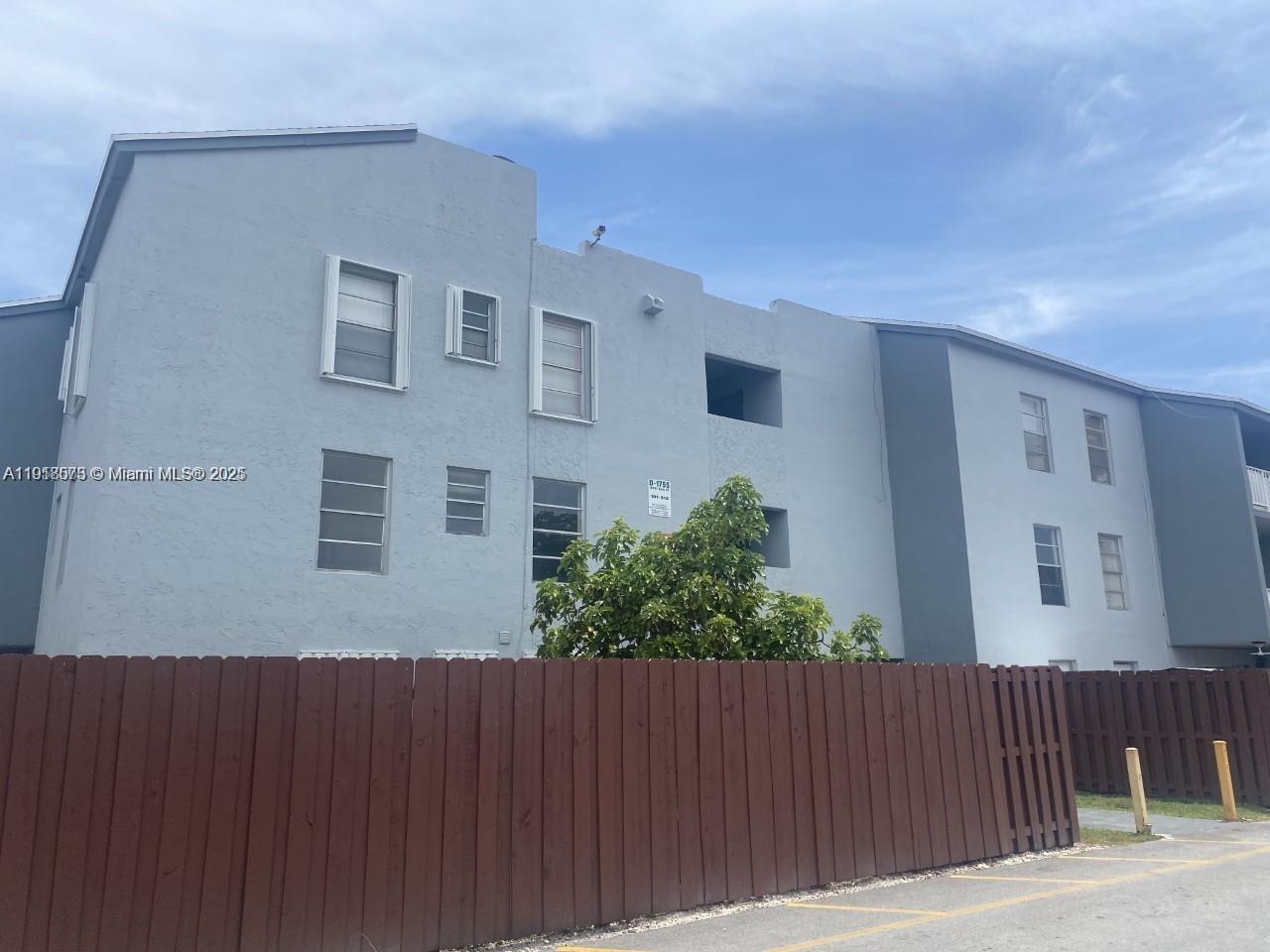 1755 West 60th Street, Unit D304 Hialeah, FL 33012 - Photo 5 of 21 a view of a house with a backyard