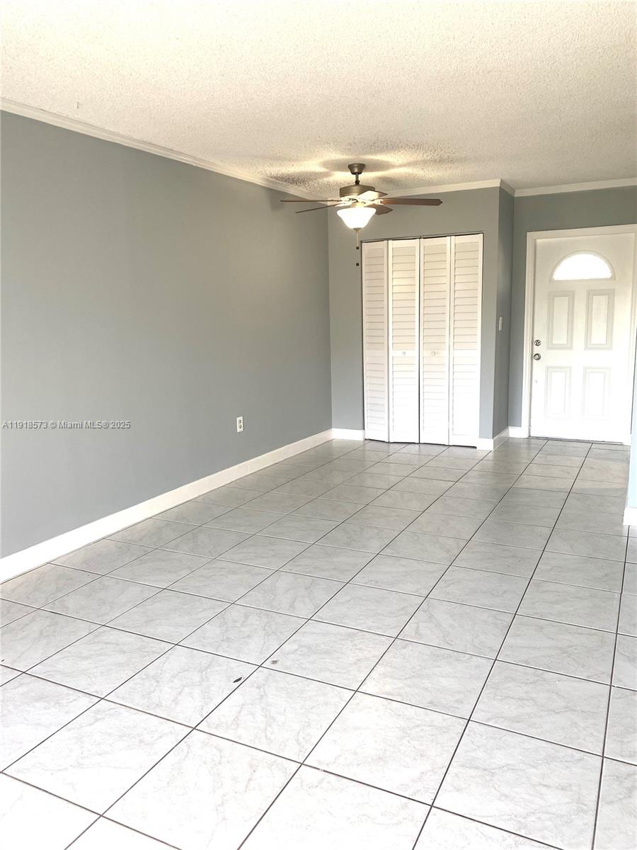 1755 West 60th Street, Unit D304 Hialeah, FL 33012 - Photo 8 of 21 a view of a livingroom with an empty space and a window