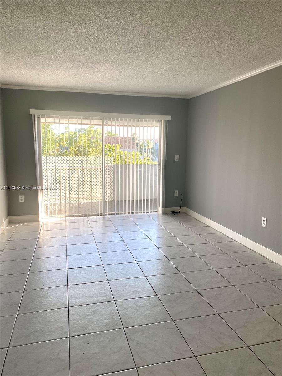 1755 West 60th Street, Unit D304 Hialeah, FL 33012 - Photo 9 of 21 a view of an empty room with a window