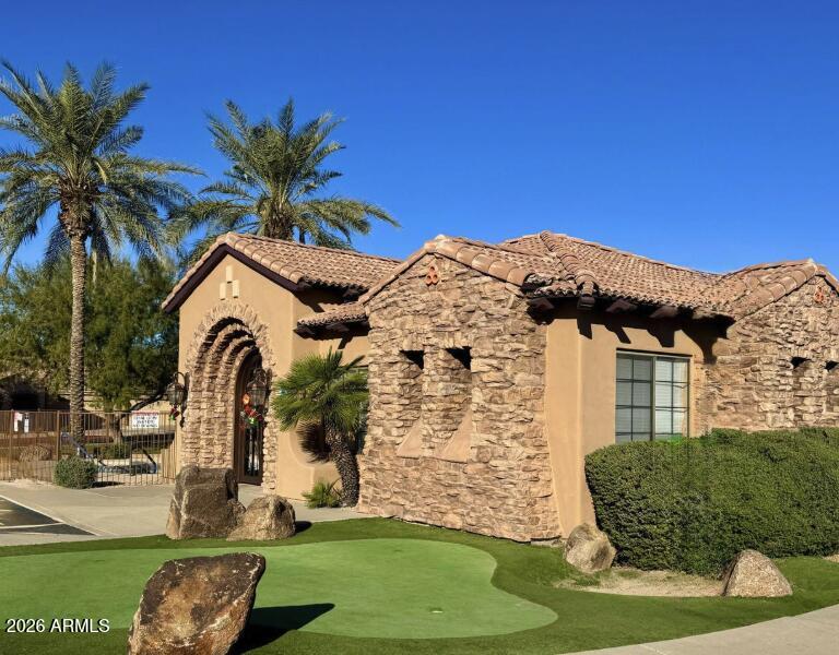 2565 South Signal Butte Road, Unit 23 Mesa, AZ 85209 - Photo 27 of 29 a front view of a house with a garden
