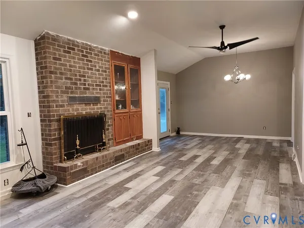 a view of an empty room with fire place and a fireplace