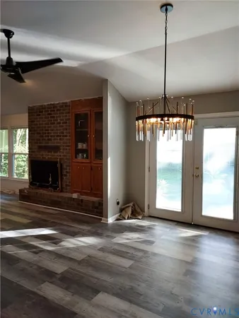 a view of an empty room with a fireplace and a window