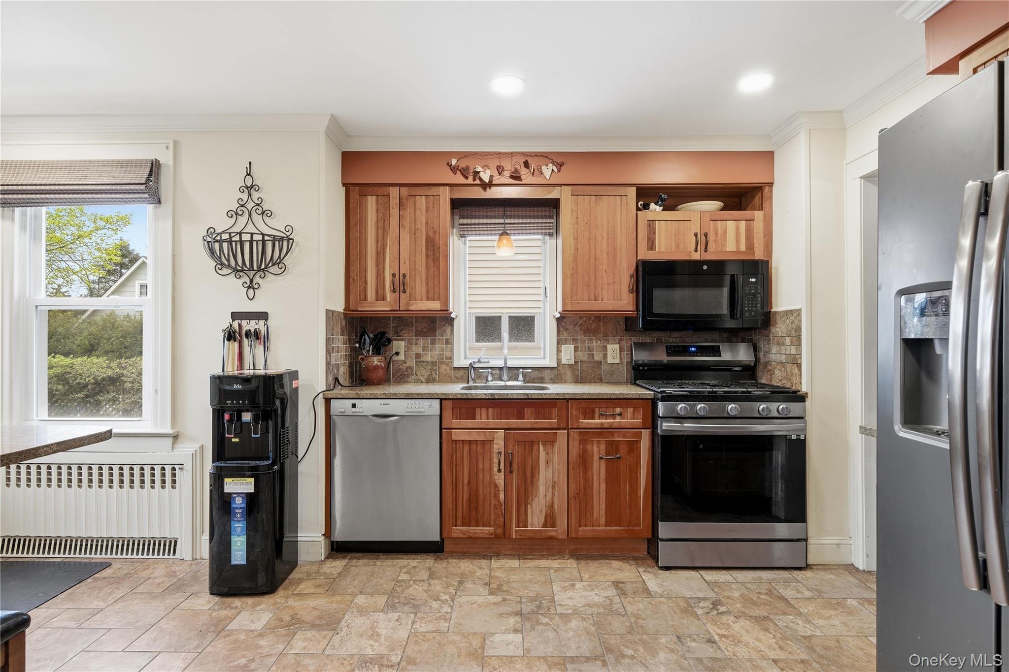 147 Church Avenue Islip, NY 11751 - Photo 17 of 40 a kitchen with stainless steel appliances granite countertop a refrigerator and a stove top oven