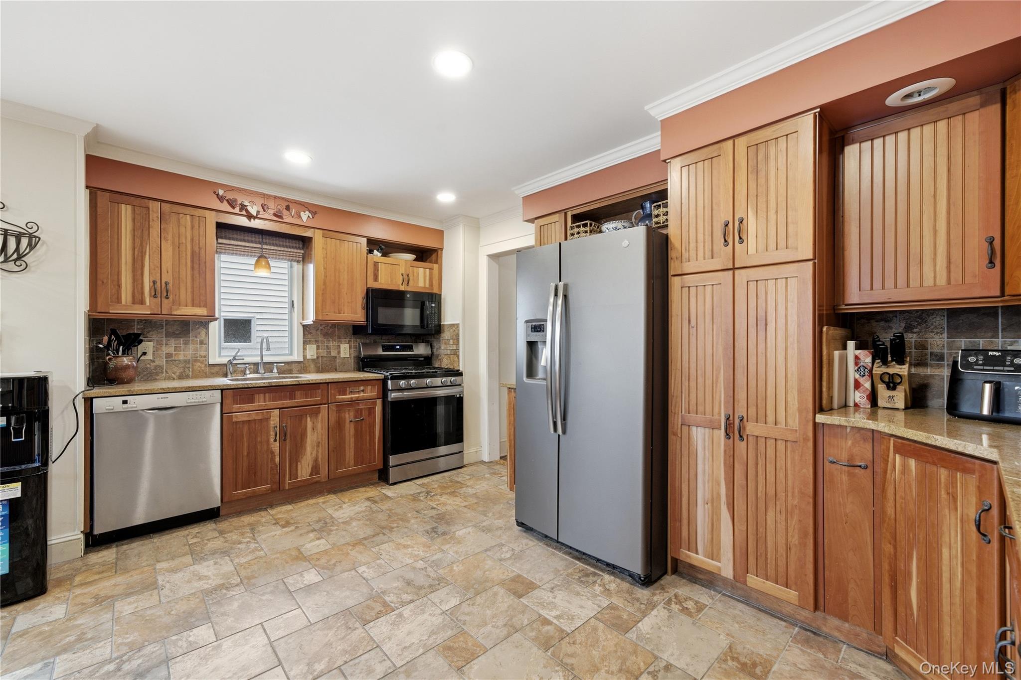 147 Church Avenue Islip, NY 11751 - Photo 18 of 40 a kitchen with stainless steel appliances granite countertop a refrigerator stove top oven a sink and dishwasher