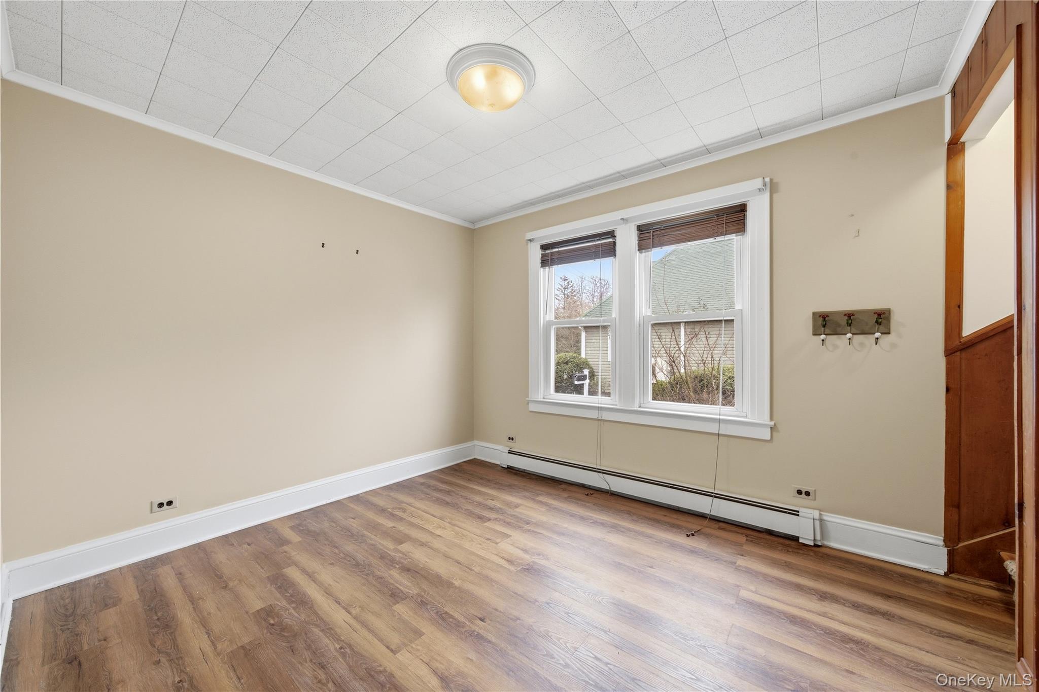 147 Church Avenue Islip, NY 11751 - Photo 21 of 40 an empty room with wooden floor and windows