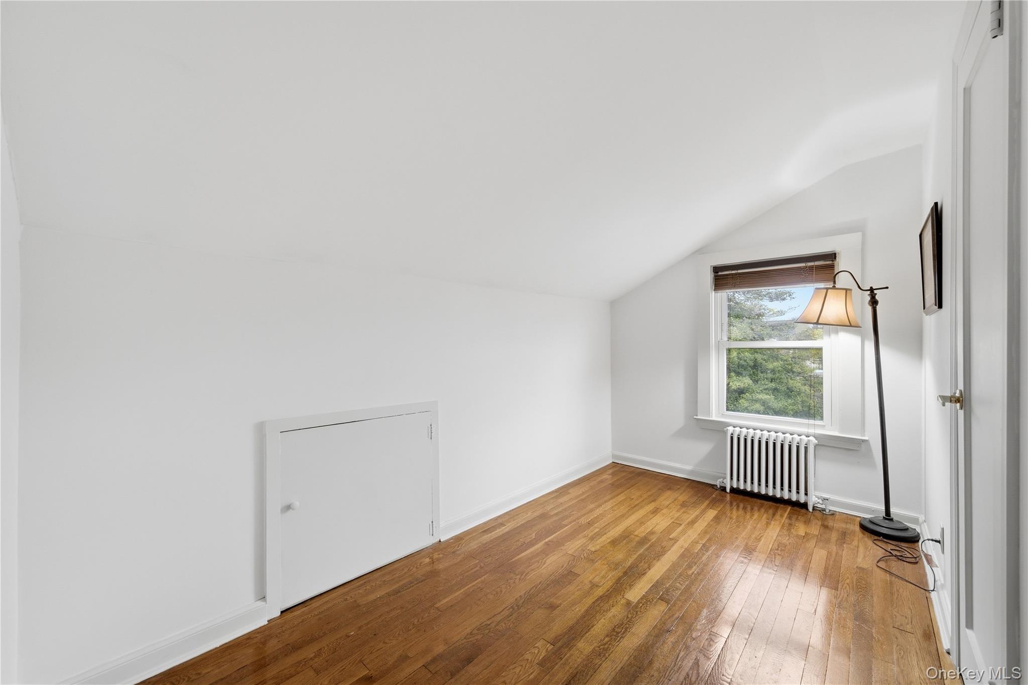 147 Church Avenue Islip, NY 11751 - Photo 29 of 40 an empty room with wooden floor and windows