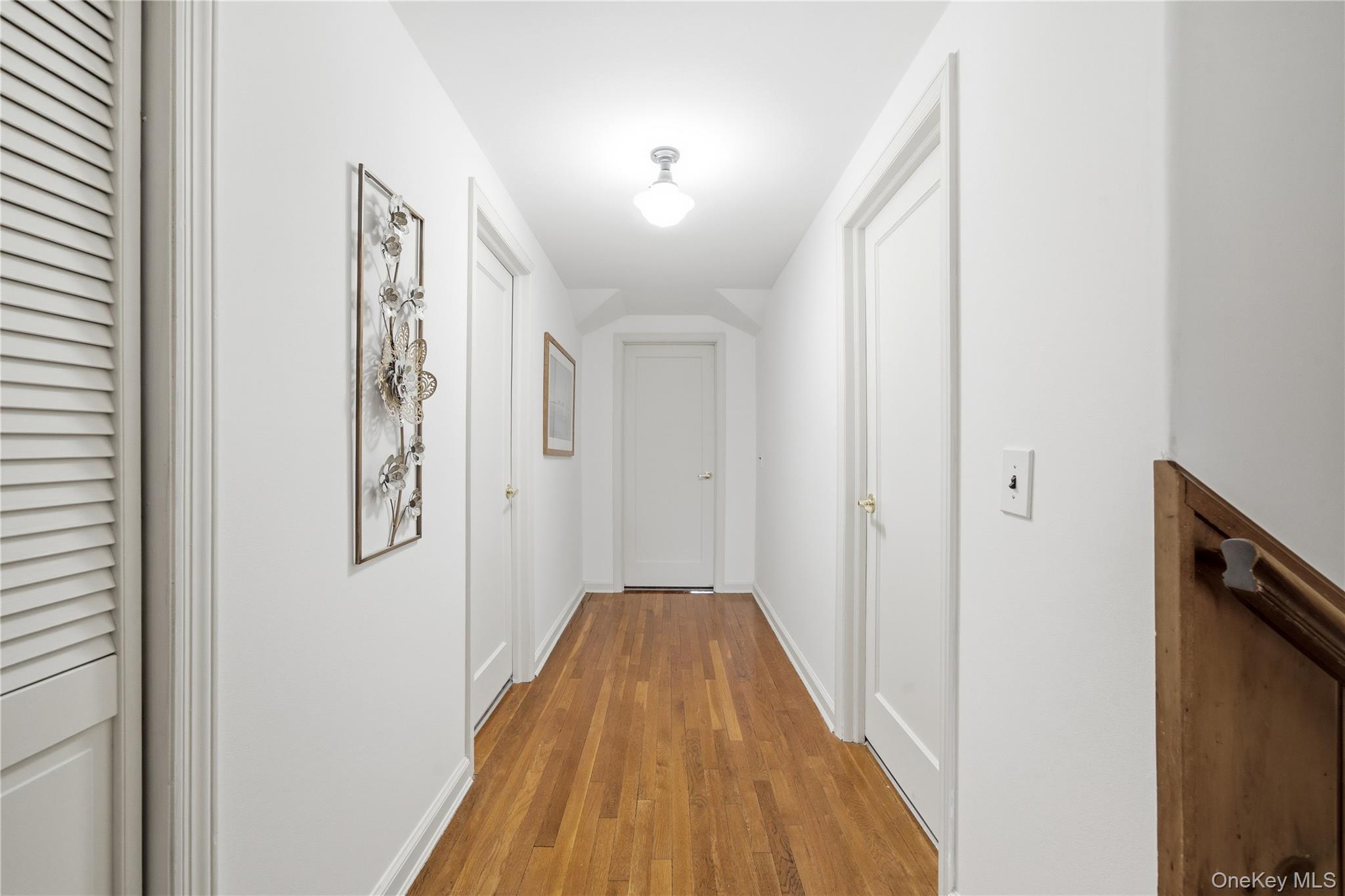 147 Church Avenue Islip, NY 11751 - Photo 34 of 40 a view of a hallway with wooden floor and staircase