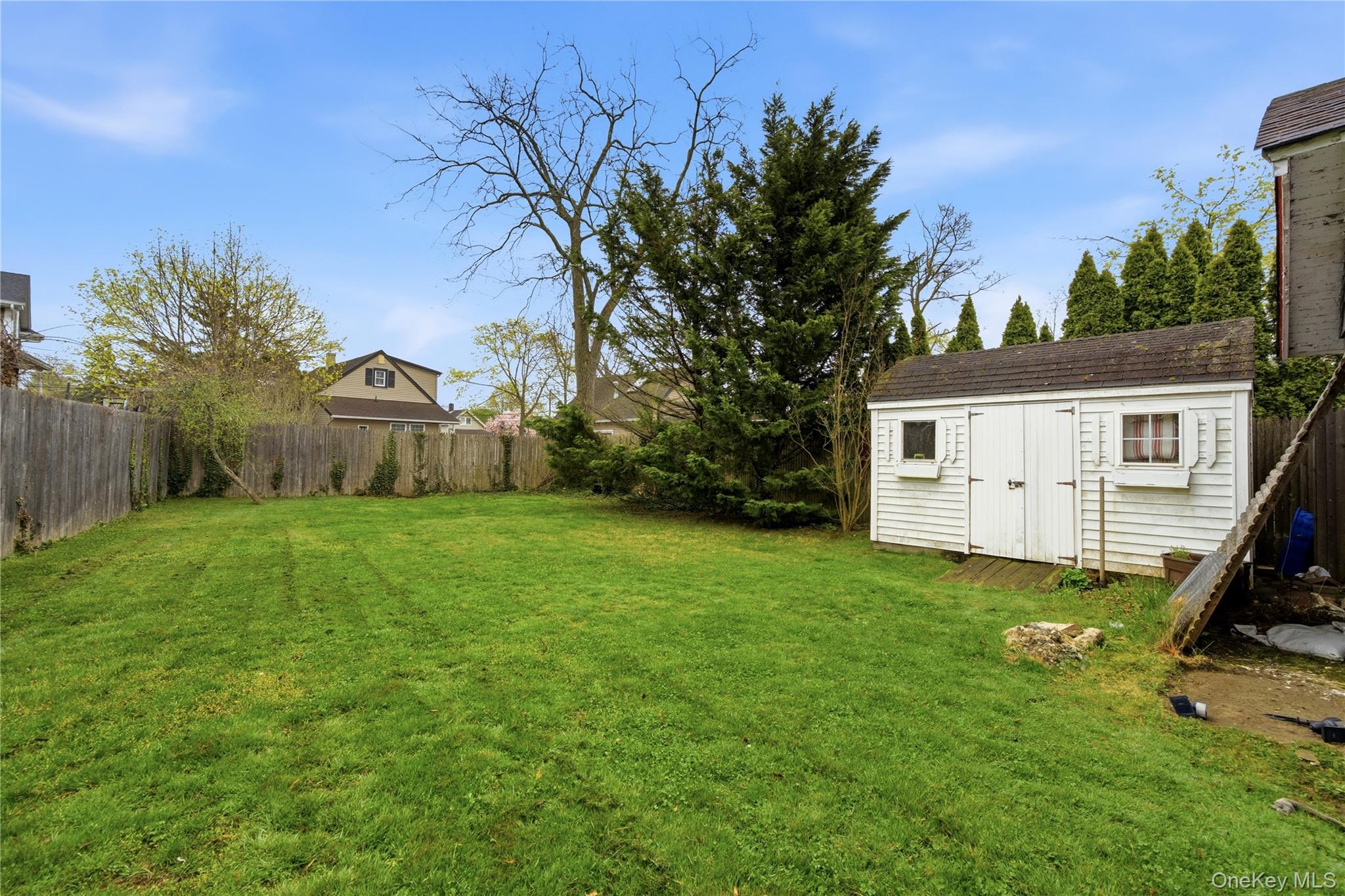 147 Church Avenue Islip, NY 11751 - Photo 35 of 40 a view of a house with backyard and a tree