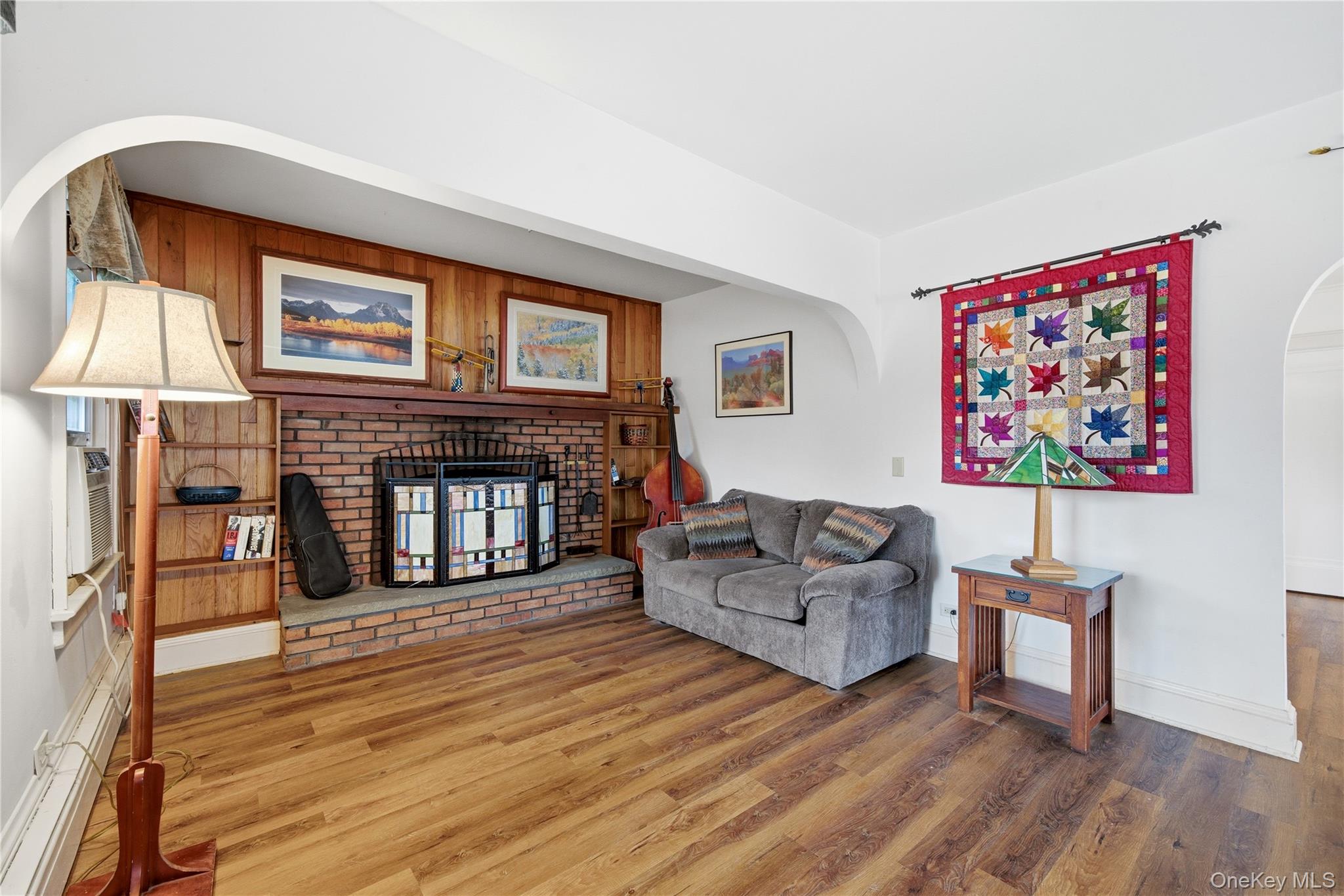 147 Church Avenue Islip, NY 11751 - Photo 6 of 40 a living room with furniture a fireplace and a flat screen tv