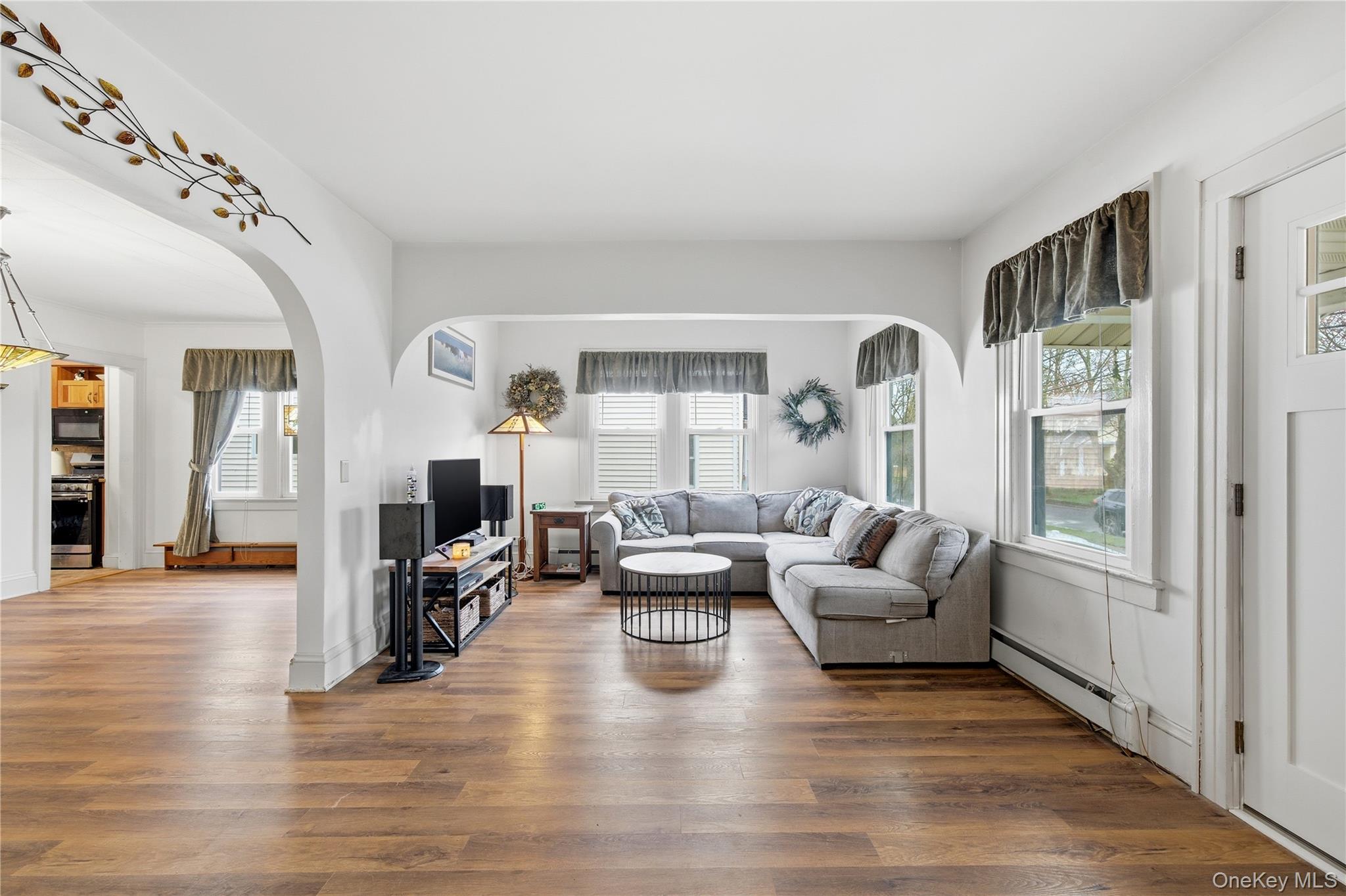 147 Church Avenue Islip, NY 11751 - Photo 7 of 40 a living room with fireplace furniture and a wooden floor