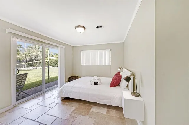 a bedroom with a bed and window