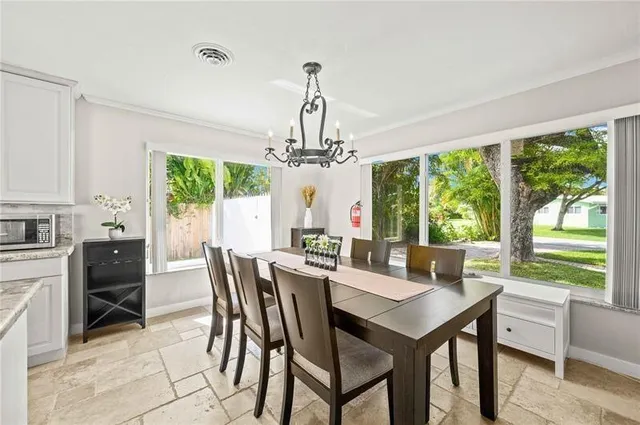 a large kitchen with granite countertop a sink and cabinets