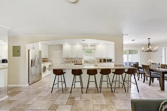 a dining hall with a dining table and chairs