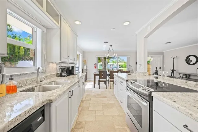 a large kitchen with granite countertop a stove and a sink