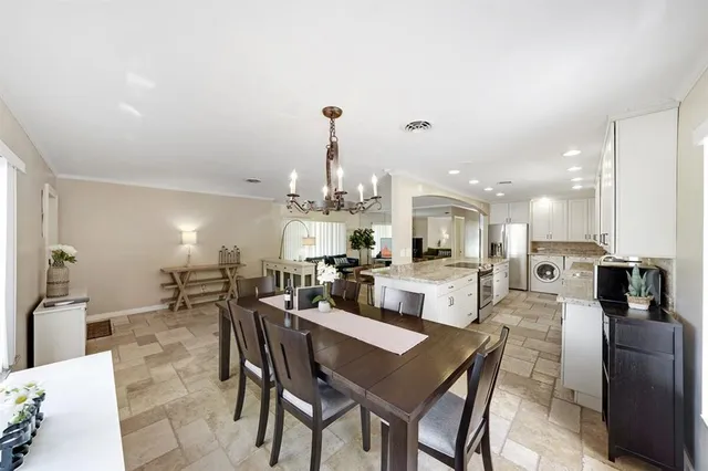a large kitchen with a table and chairs