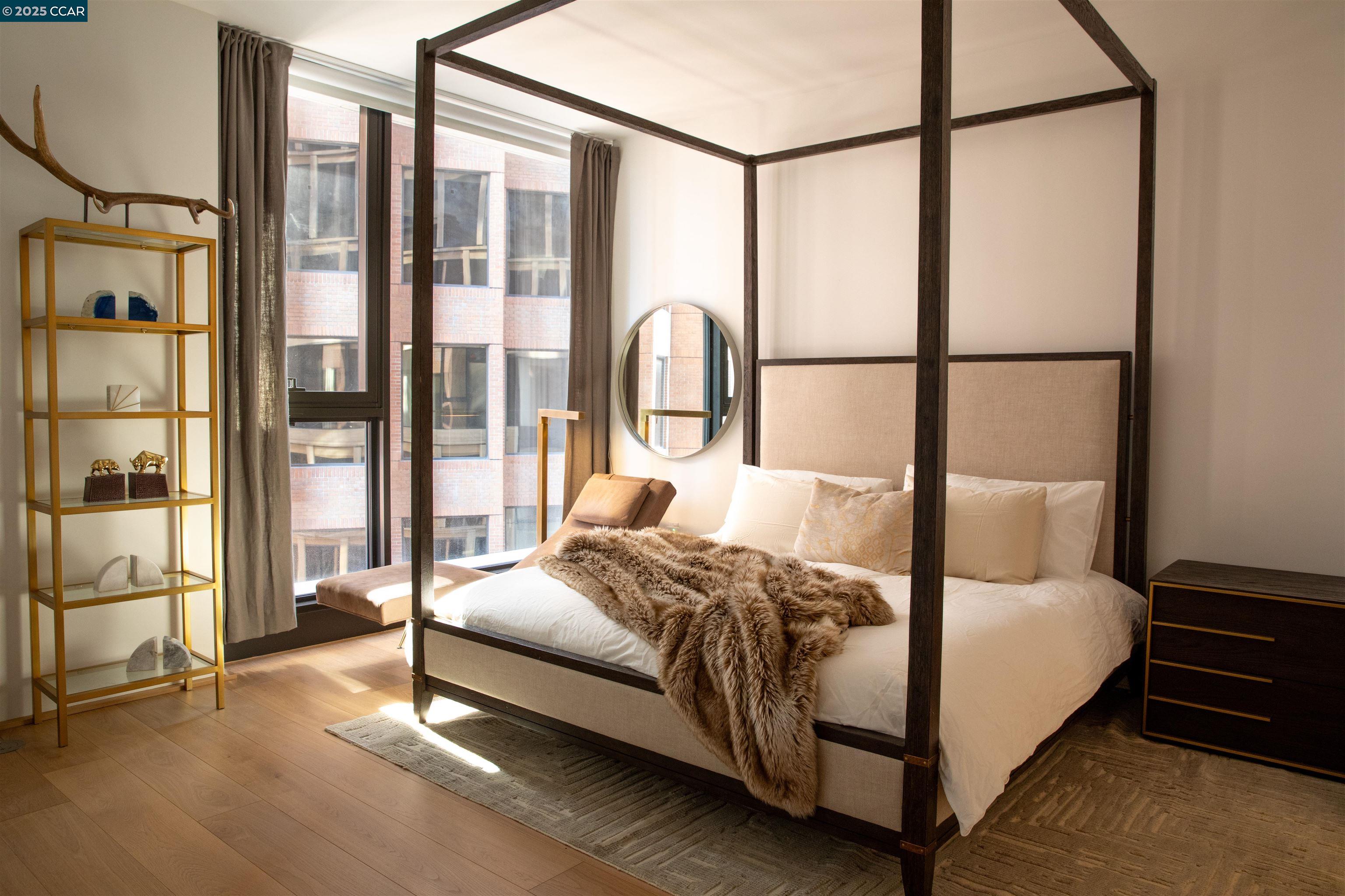 1 Steuart Street, Unit 1103 San Francisco, CA 94105 - Photo 12 of 31 a bedroom with a bed and a large window