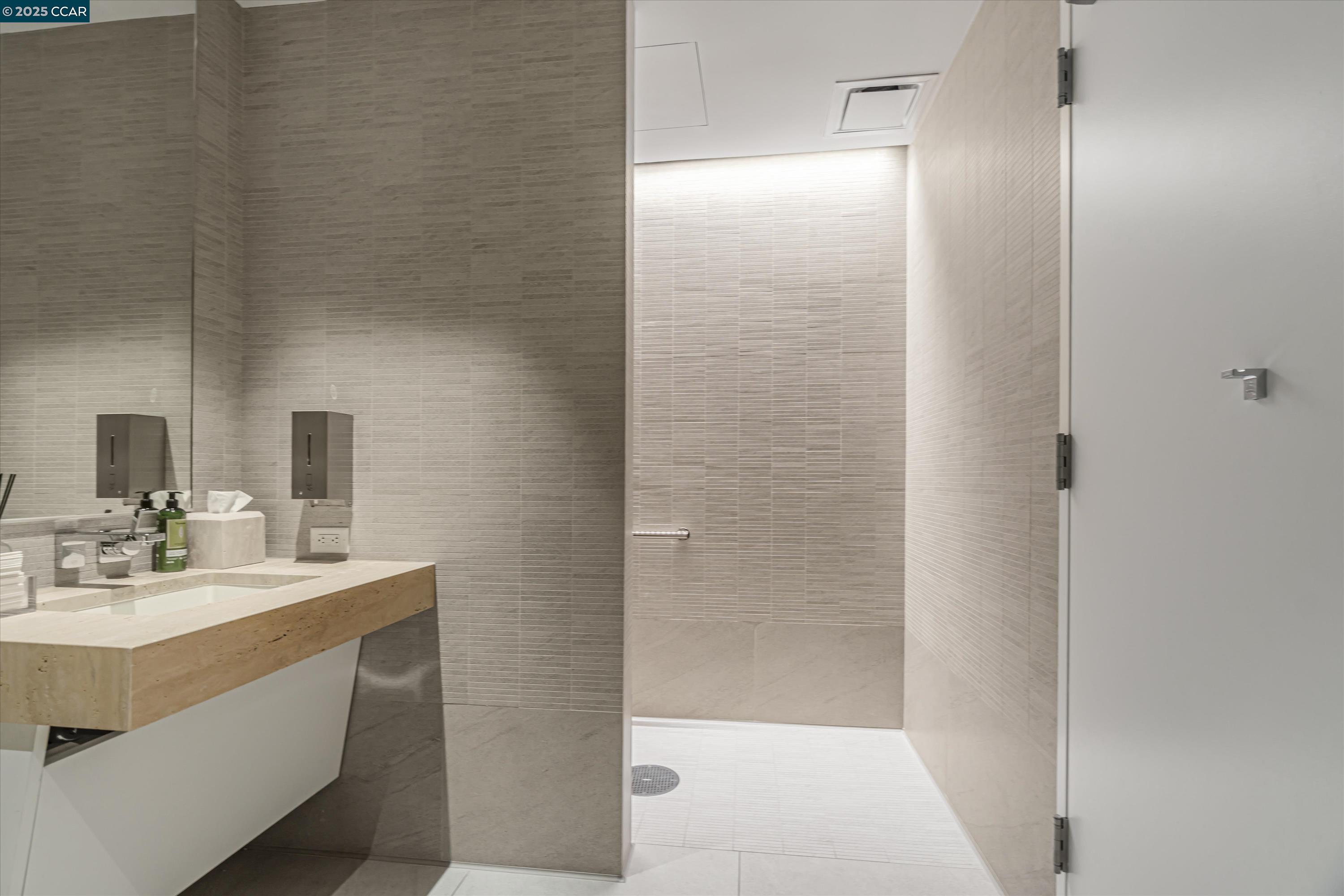 1 Steuart Street, Unit 1103 San Francisco, CA 94105 - Photo 23 of 31 a bathroom with a sink shower and a mirror