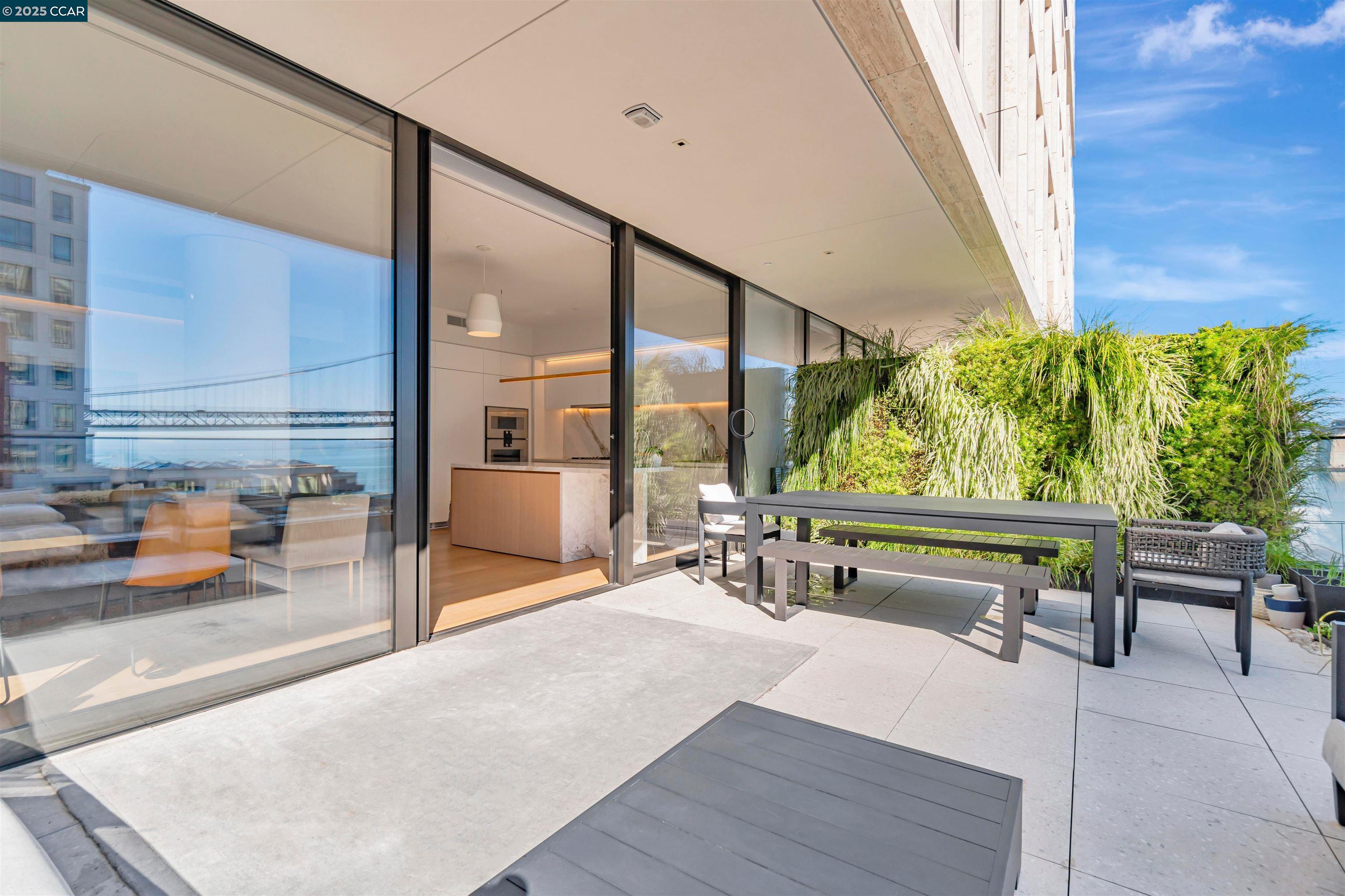 1 Steuart Street, Unit 1103 San Francisco, CA 94105 - Photo 7 of 31 a living room with furniture and a large window
