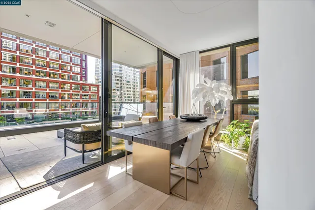 a dining room with furniture and a floor to ceiling window