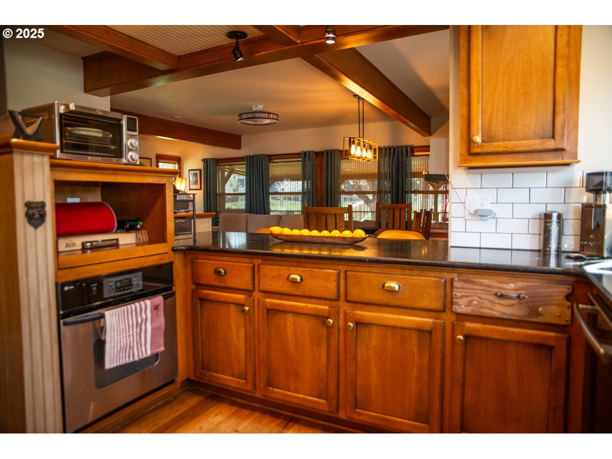 62725 Eagle Road Bend, OR 97701 - Photo 14 of 39 a kitchen with stainless steel appliances granite countertop a stove and cabinets