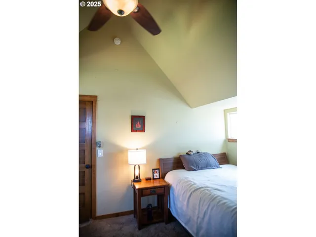 a bedroom with a bed and a painting on the wall