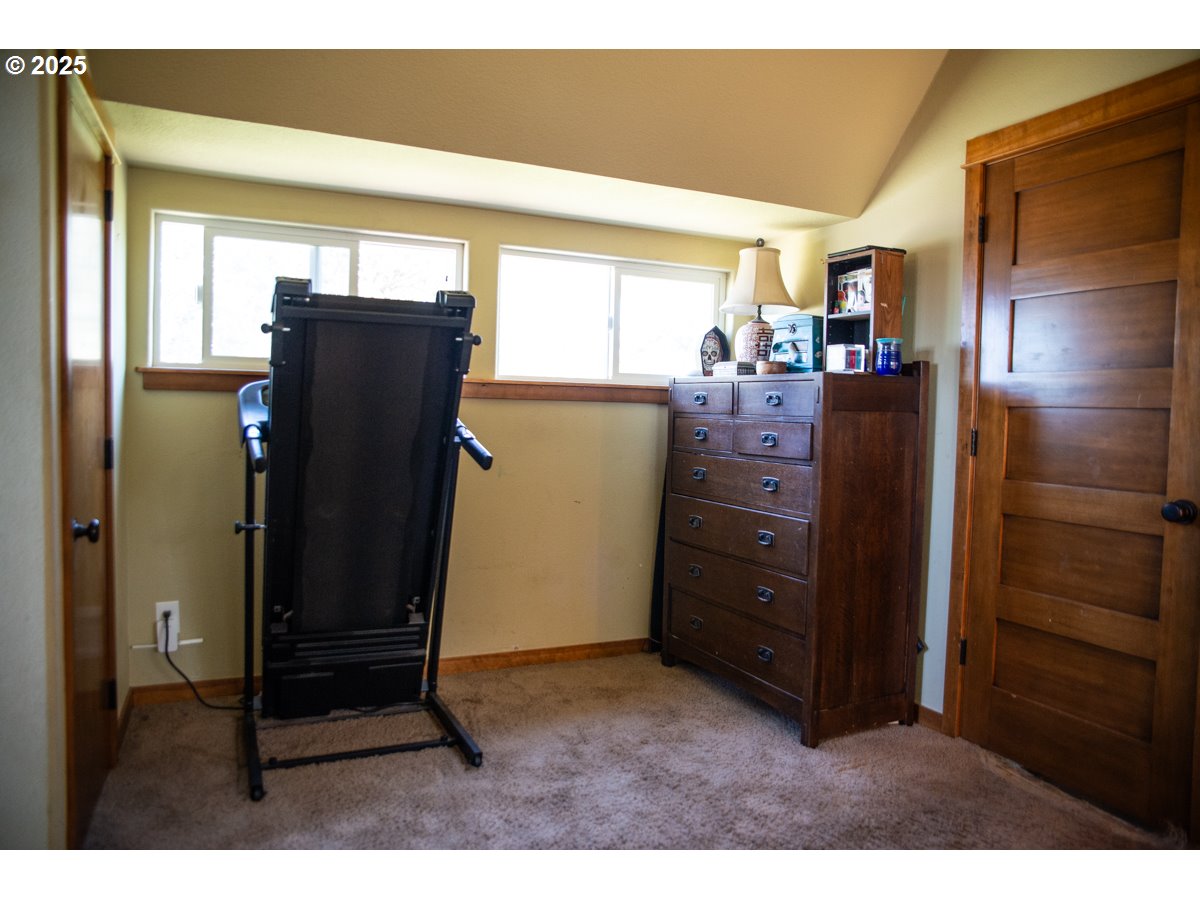 62725 Eagle Road Bend, OR 97701 - Photo 25 of 39 a view of walk in closet with window and cabinet