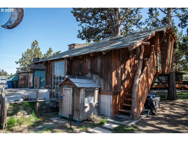 a front view of house with swing and plants