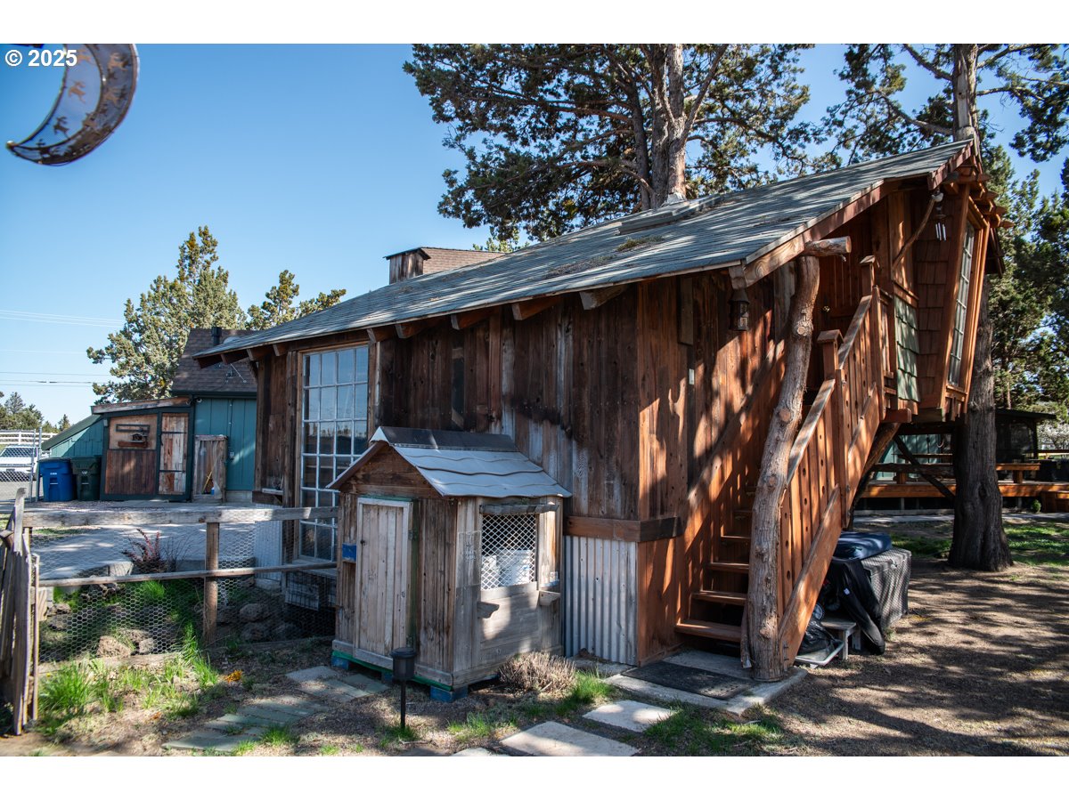 62725 Eagle Road Bend, OR 97701 - Photo 31 of 39 a front view of house with swing and plants