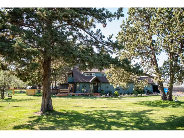a view of a house with backyard porch and sitting area