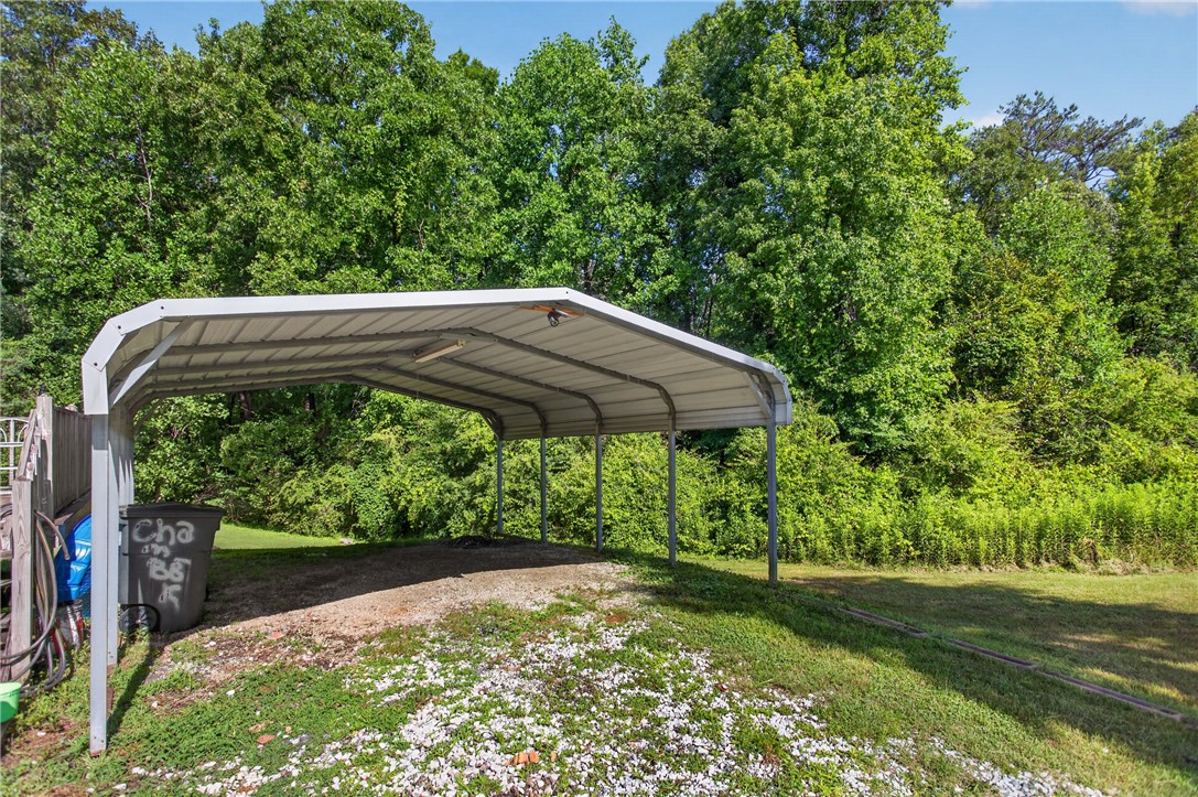418 Chauga Road Westminster, SC 29693 - Photo 24 of 38 A spacious carport offers convenient, sheltered parking on a verdant lot.