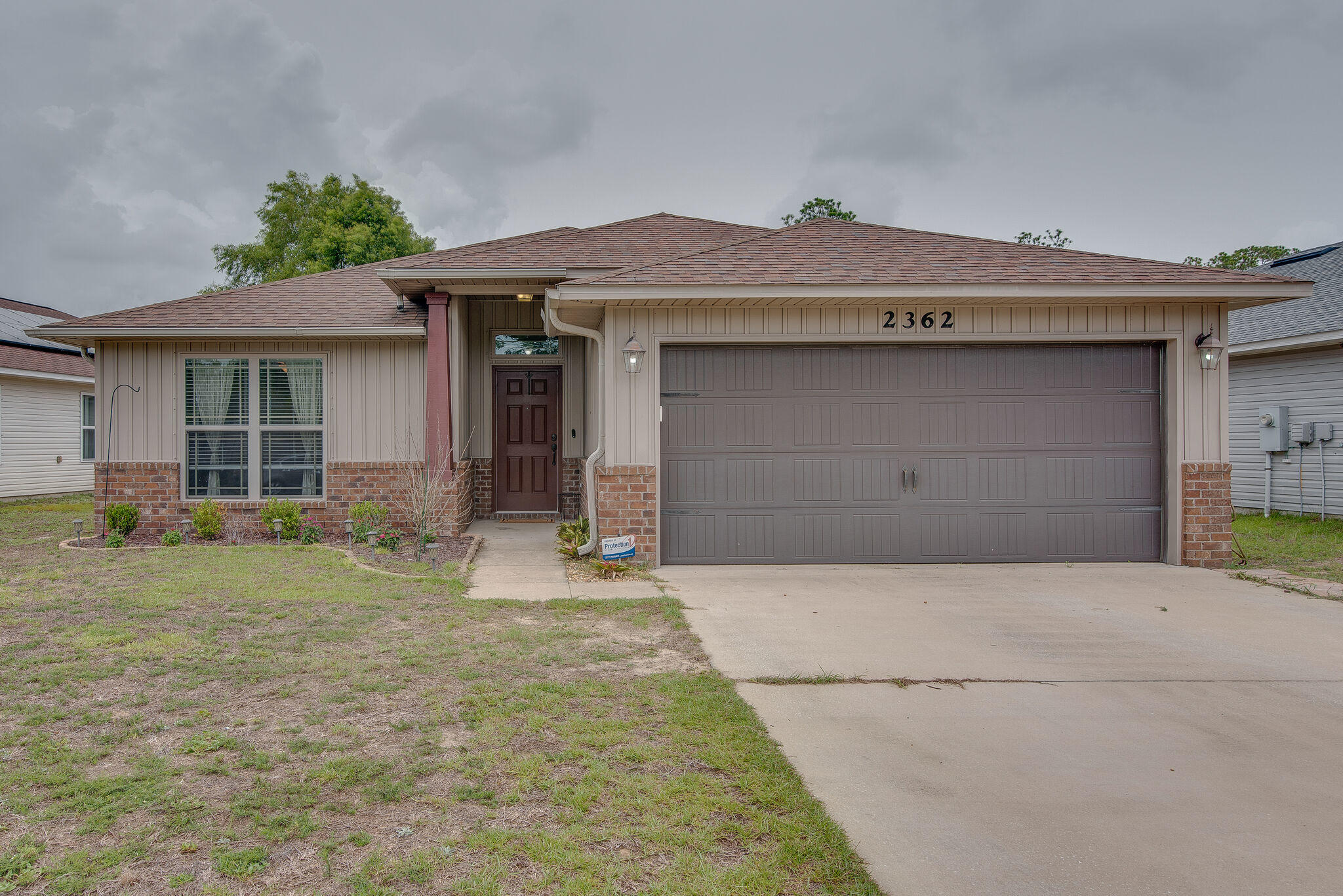 2362 Duncan Ridge Drive Navarre, FL 32566 - Photo 1 of 28 a front view of a house with a yard and garage