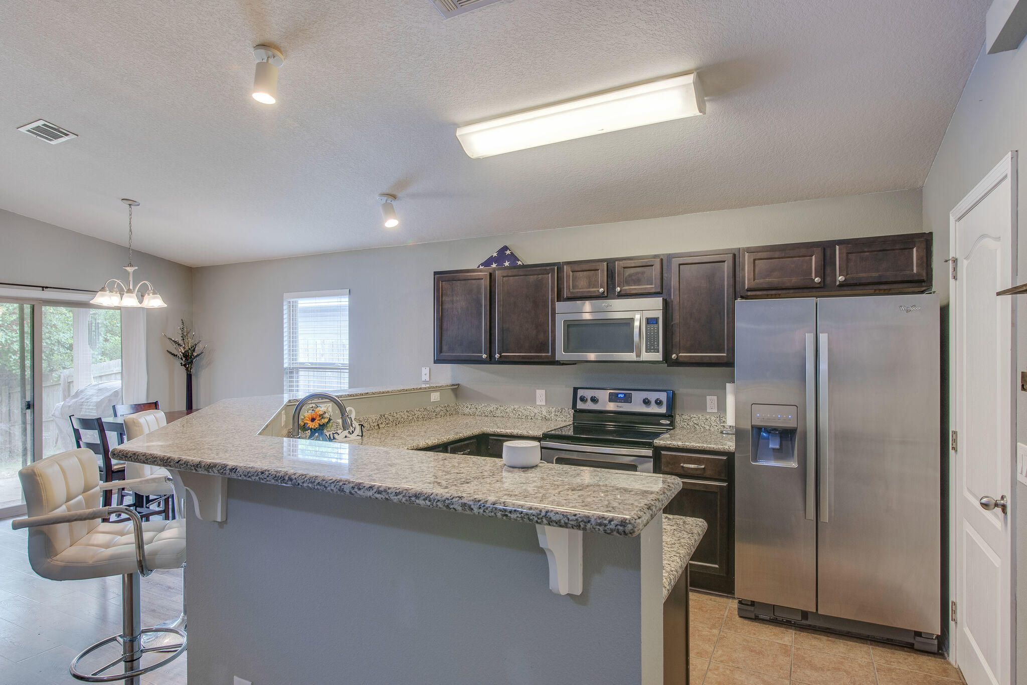 2362 Duncan Ridge Drive Navarre, FL 32566 - Photo 13 of 28 a kitchen with stainless steel appliances granite countertop a sink refrigerator and microwave