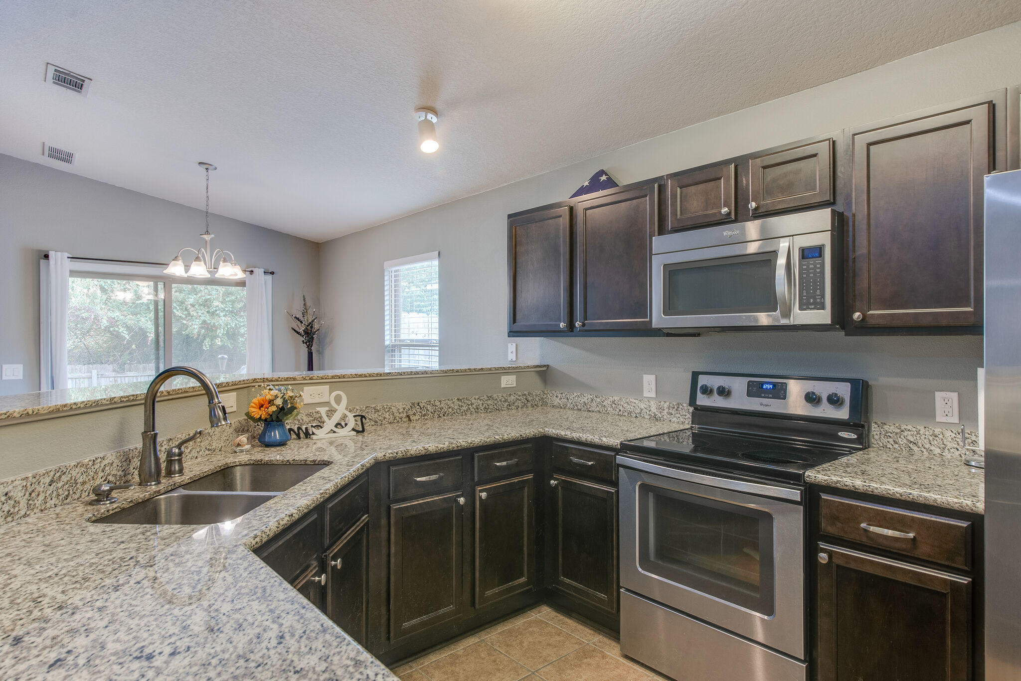 2362 Duncan Ridge Drive Navarre, FL 32566 - Photo 14 of 28 a kitchen with stainless steel appliances granite countertop a sink stove and microwave