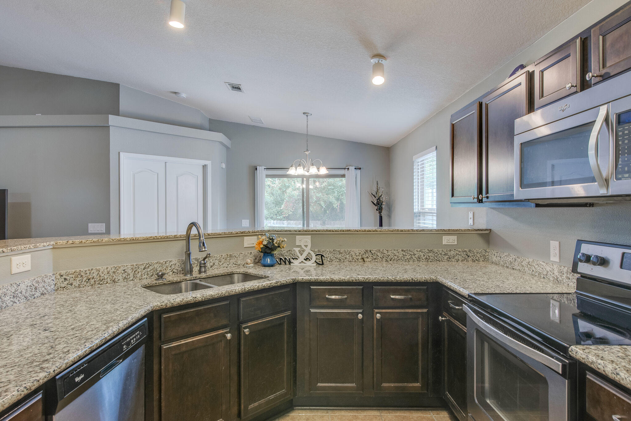 2362 Duncan Ridge Drive Navarre, FL 32566 - Photo 15 of 28 a kitchen with stainless steel appliances granite countertop a sink stove and cabinets