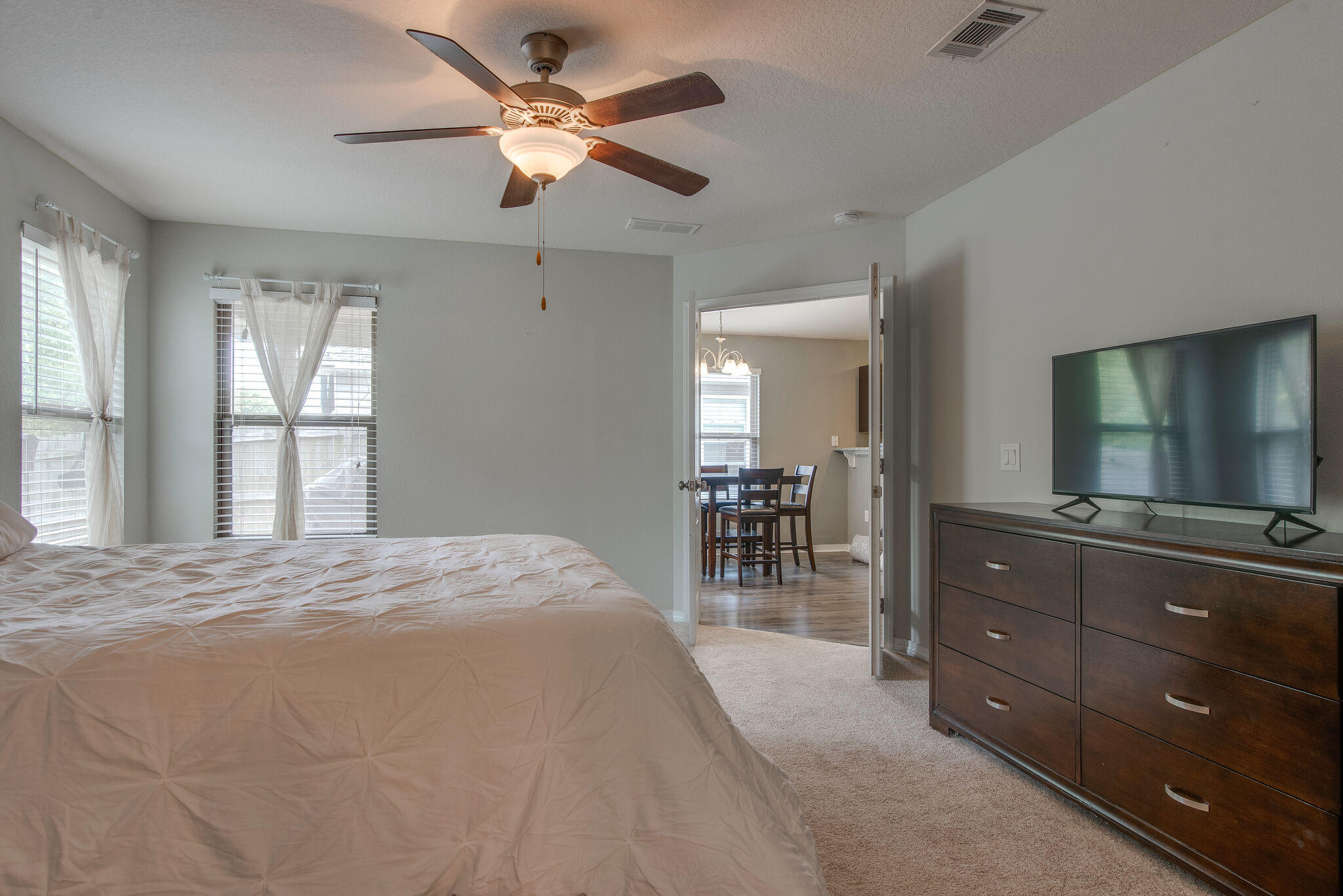 2362 Duncan Ridge Drive Navarre, FL 32566 - Photo 19 of 28 a bedroom with a bed a chandelier and a mirror