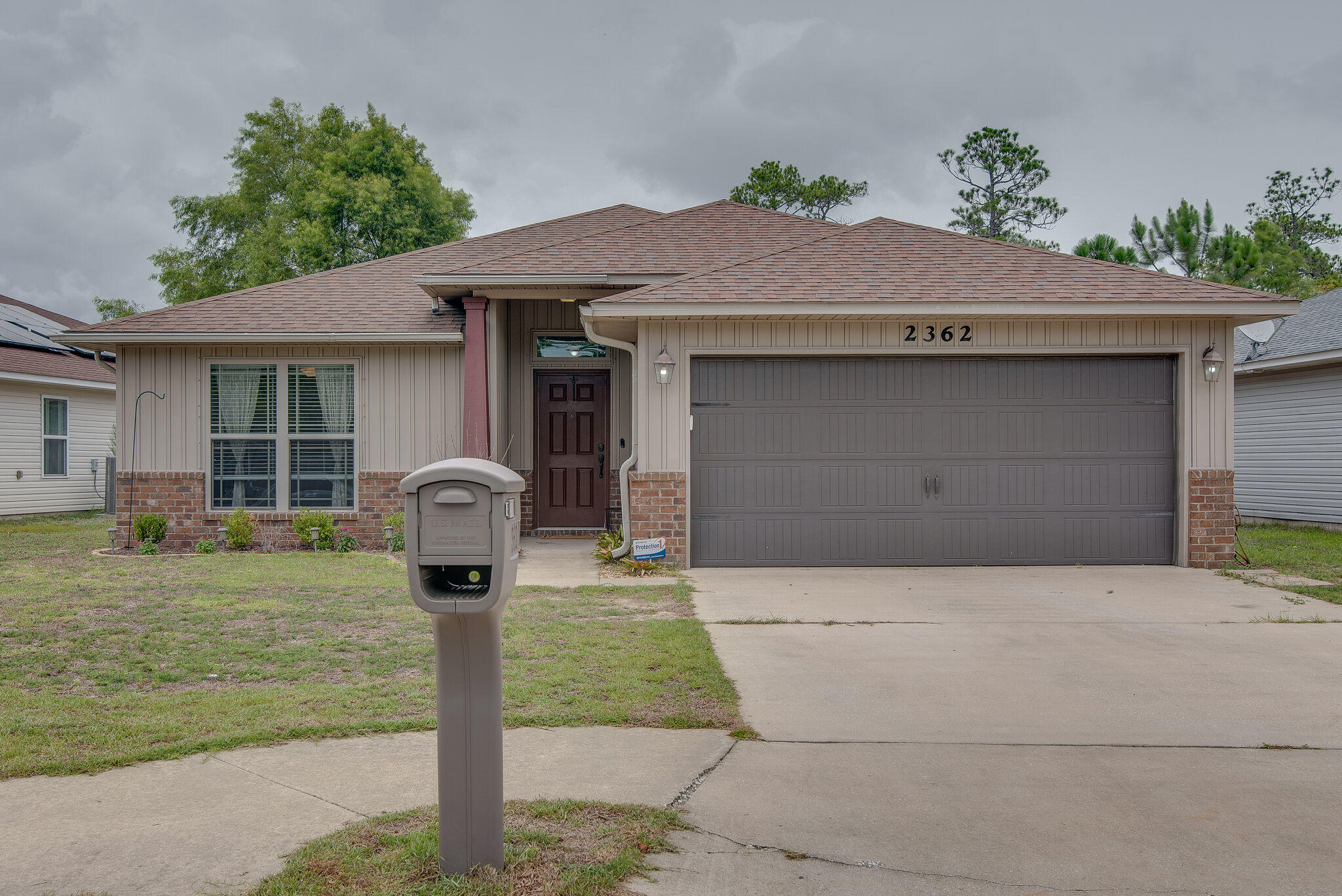 2362 Duncan Ridge Drive Navarre, FL 32566 - Photo 2 of 28 a front view of a house with garden