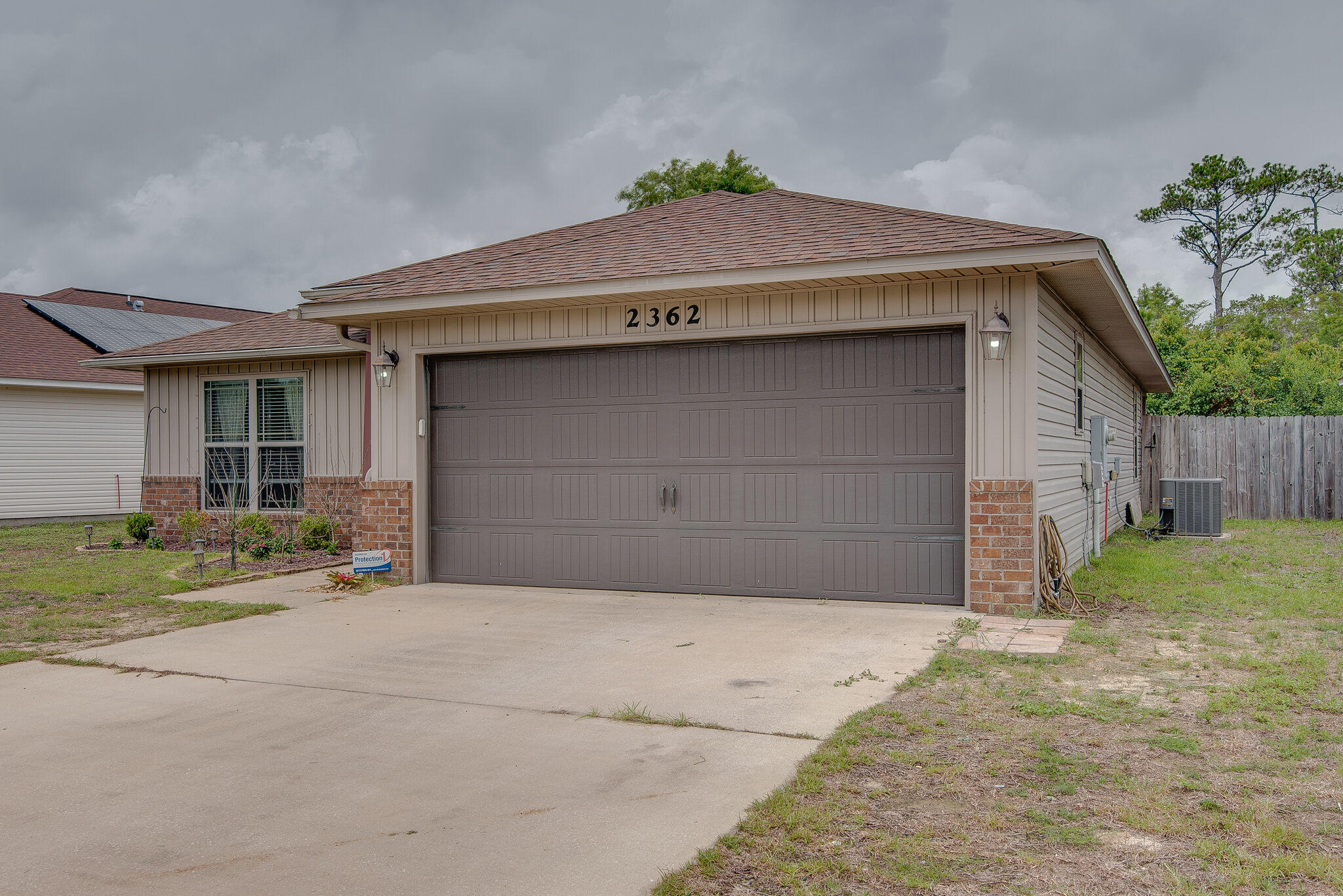 2362 Duncan Ridge Drive Navarre, FL 32566 - Photo 3 of 28 a front view of a house with a yard and garage